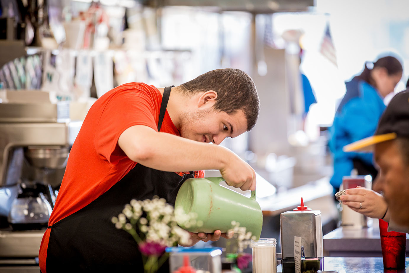 Man pouring something into glass