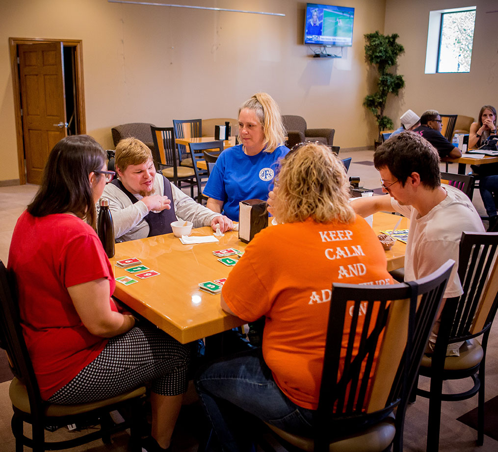 People sitting at table playing cards