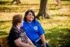 dfs employee and client sitting in park